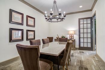 a dining room with a large table and chairs and a chandelier